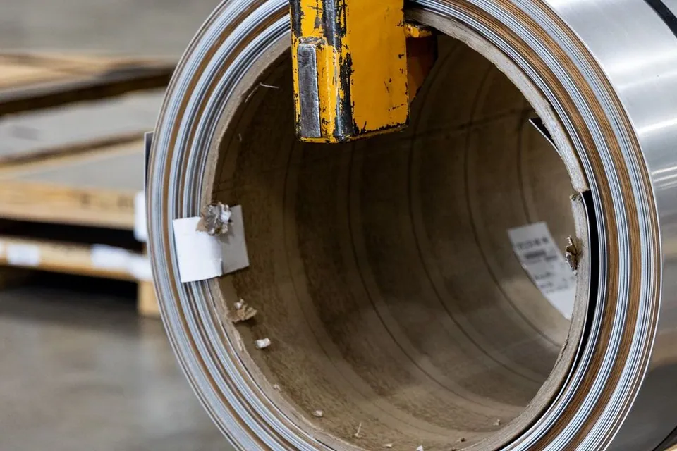 Coiled metal sheet stored in an industrial warehouse